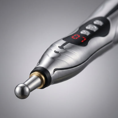 Tinnito Pen detail close-up — metal ball tip, brass collar, and control panel (1:1 square)